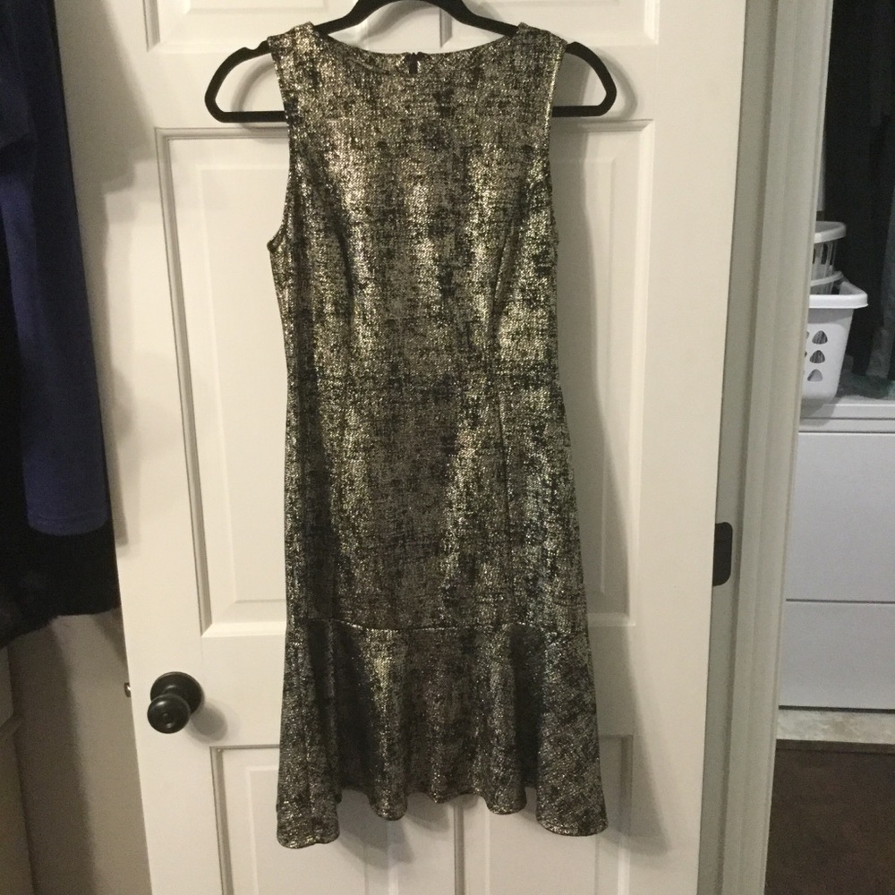 Midi length fitted black and gold cocktail dress.